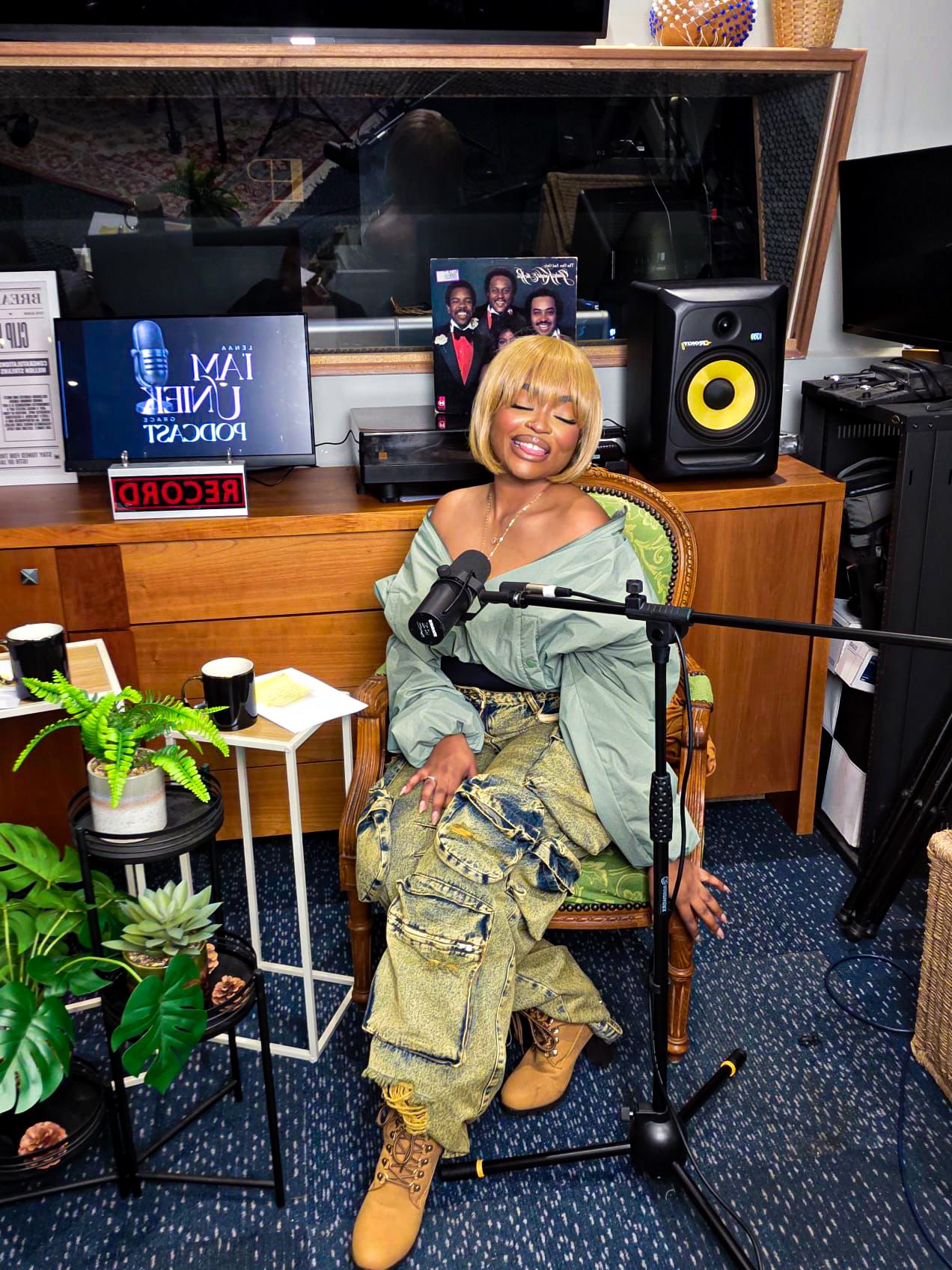 Lenaa I AM seated in the I AM Uniek Podcast studio beside a microphone